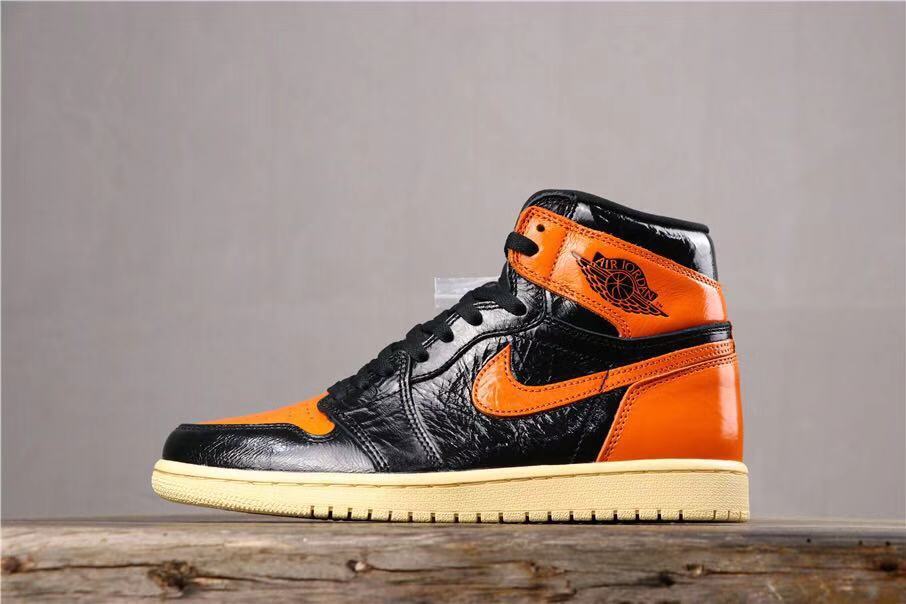 Air Jordan 1 Retro High OG Sneakers in Black and Orange - product image from the listing.
