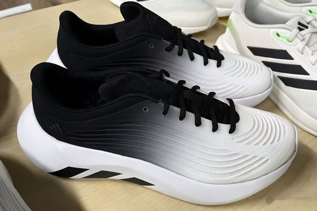 Adidas 4DFWD Sneakers in White and Black - product image from the listing.