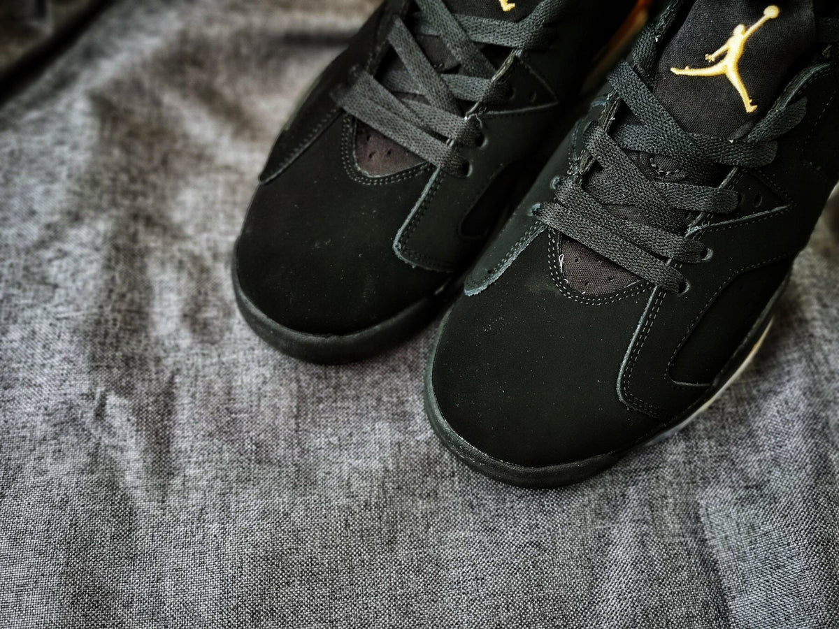 Air Jordan 6 High-Top Sneakers in Black and Gold - product image from the listing.