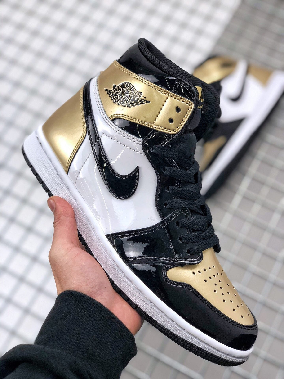 Air Jordan 1 High Gold Toe Sneakers in Black and Gold - product image from the listing.