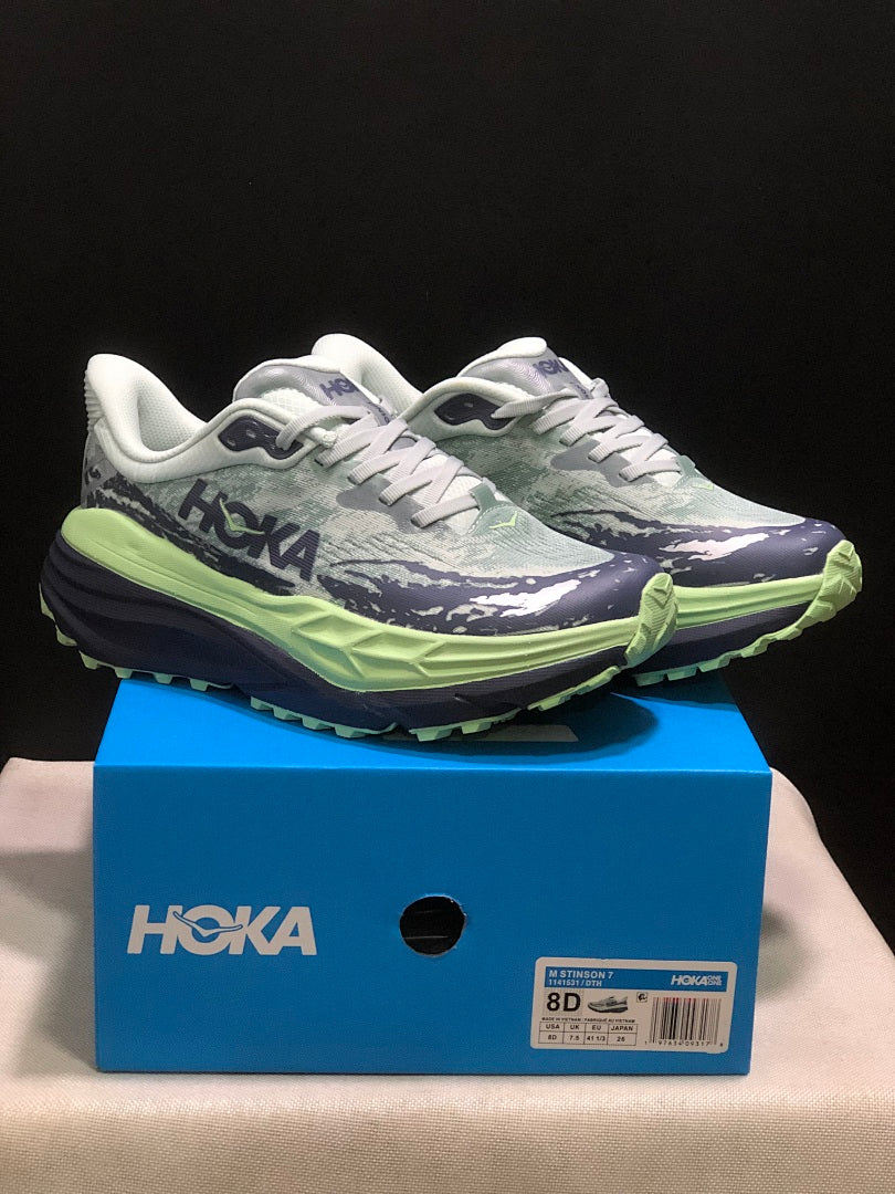 HOKA Stinson 7 Trail Running Shoes, in Green and Navy - product image from the listing.