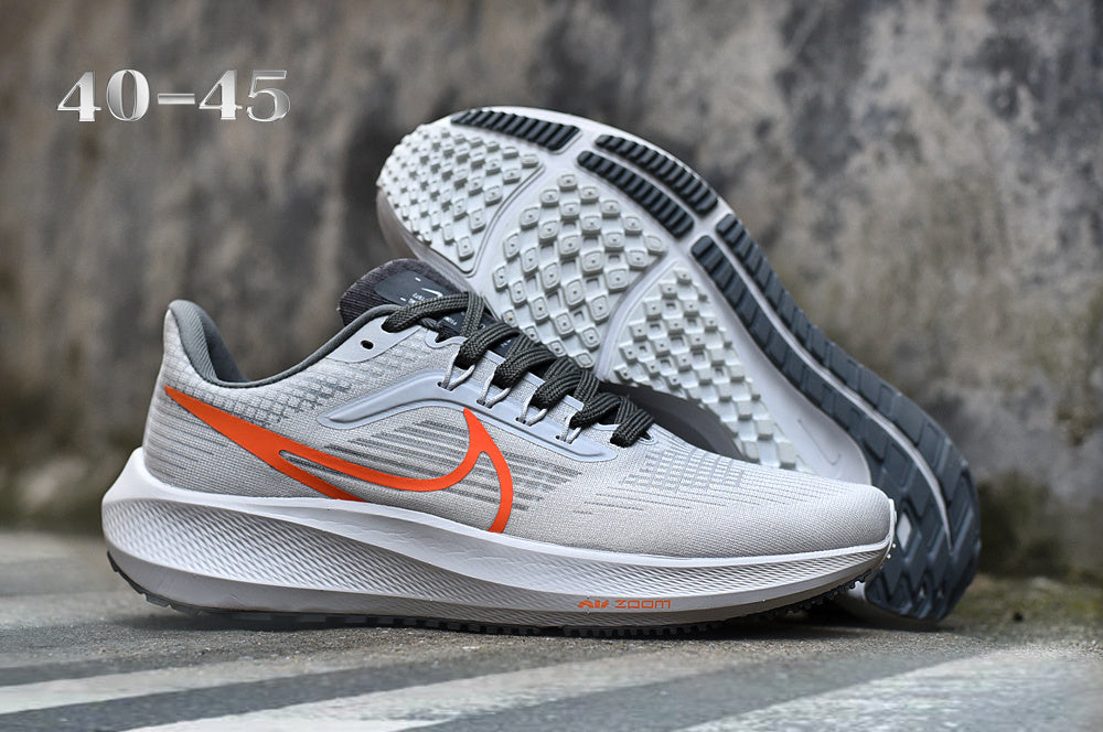 Nike Road Shoes for Running in Light Gray with Orange Swoosh - product image from the listing.