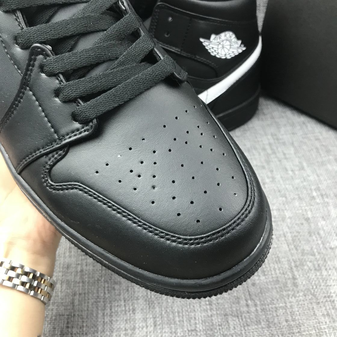 Air Jordan 1 Mid Sneakers in Black White 554724-049 - product image from the listing.
