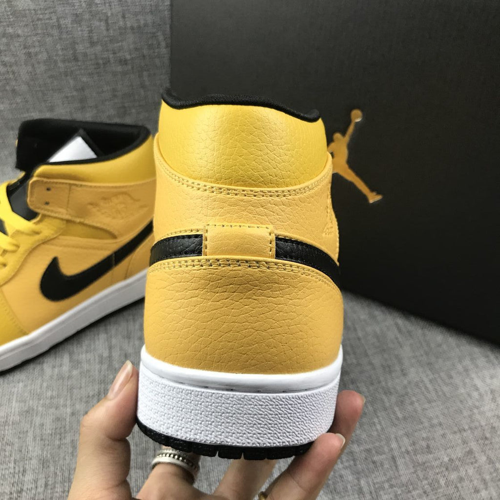 Air Jordan 1 Mid Yellow Ochre Sneakers in Black 554724-700 - product image from the listing.