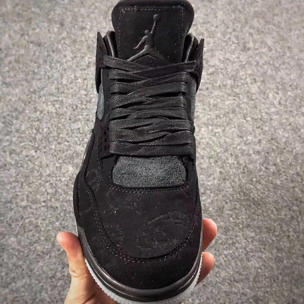 Jordan 4 KAWS Graffiti High-Top Sneakers in Black - product image from the listing.