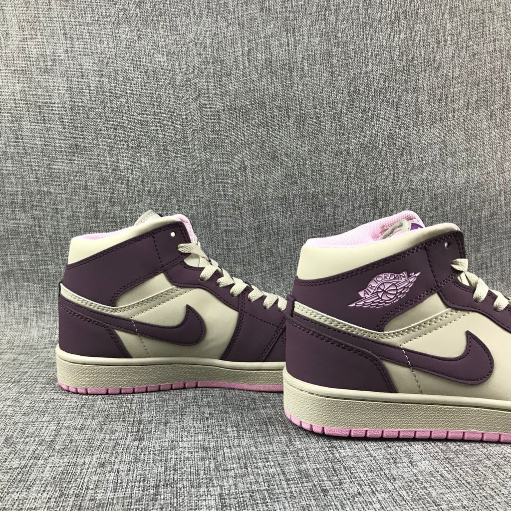 Air Jordan 1 Mid Sneakers in Pink Purple 555112-500 - product image from the listing.