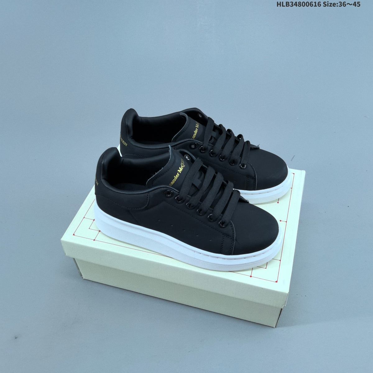 Alexander McQueen Oversized Low-Top Sneakers, in White and Black - product image from the listing.