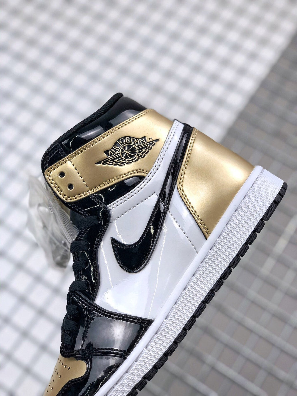 Air Jordan 1 High Gold Toe Sneakers in Black and Gold - product image from the listing.