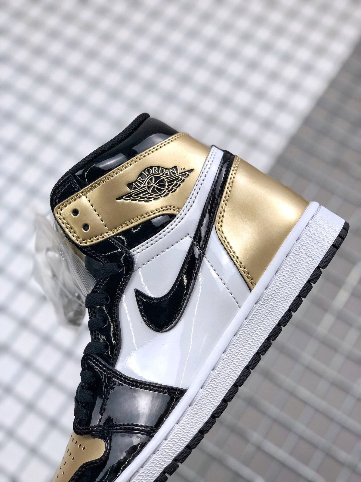 Air Jordan 1 High Gold Toe Sneakers in Black and Gold - product image from the listing.
