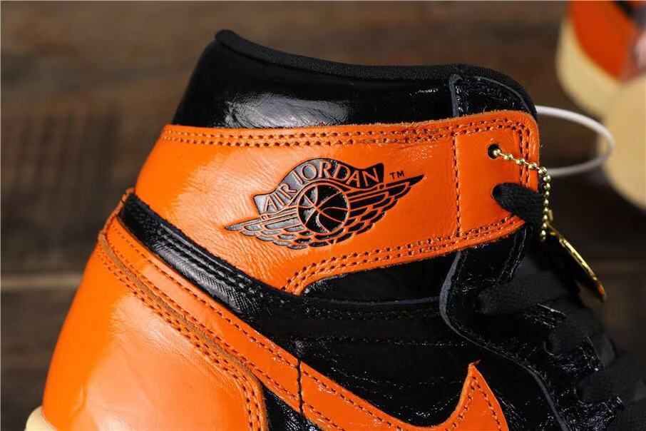 Air Jordan 1 Retro High OG Sneakers in Black and Orange - product image from the listing.