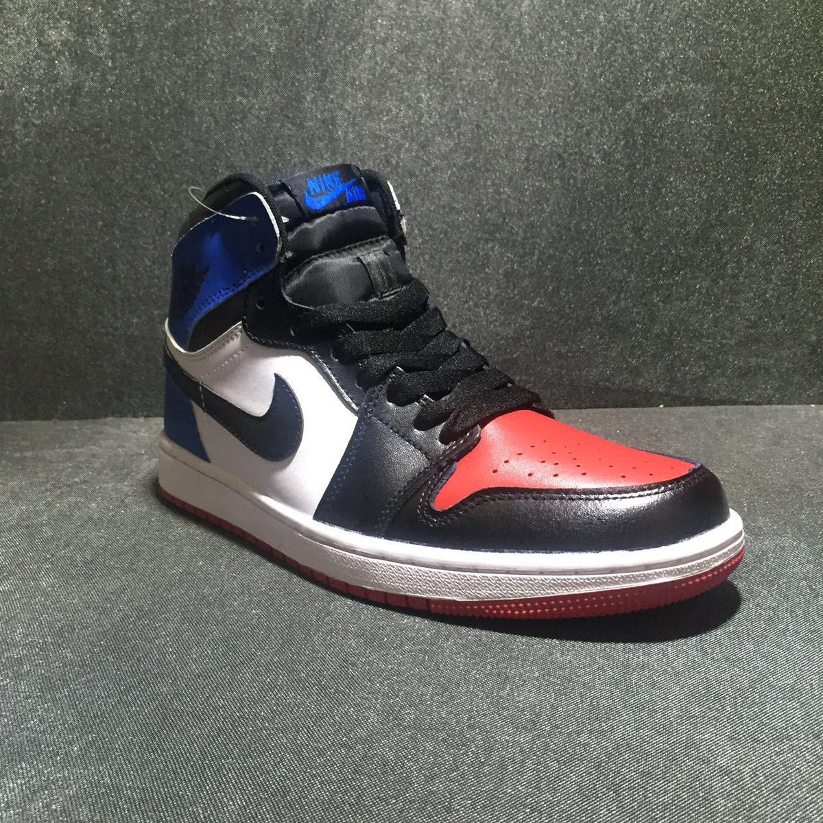 Jordan 1 High Three-Color Sneaker in Black, in Blue and Red - product image from the listing.