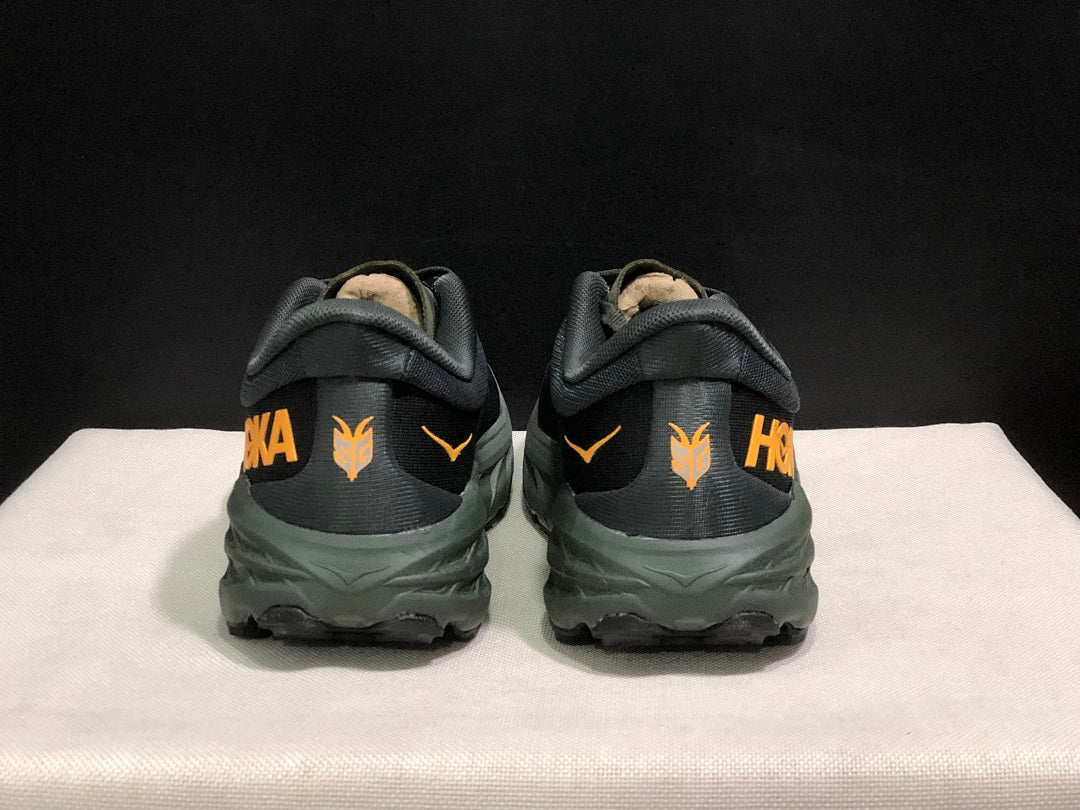 HOKA Speedgoat 5 Trail Running Shoes, in Black and Olive - product image from the listing.