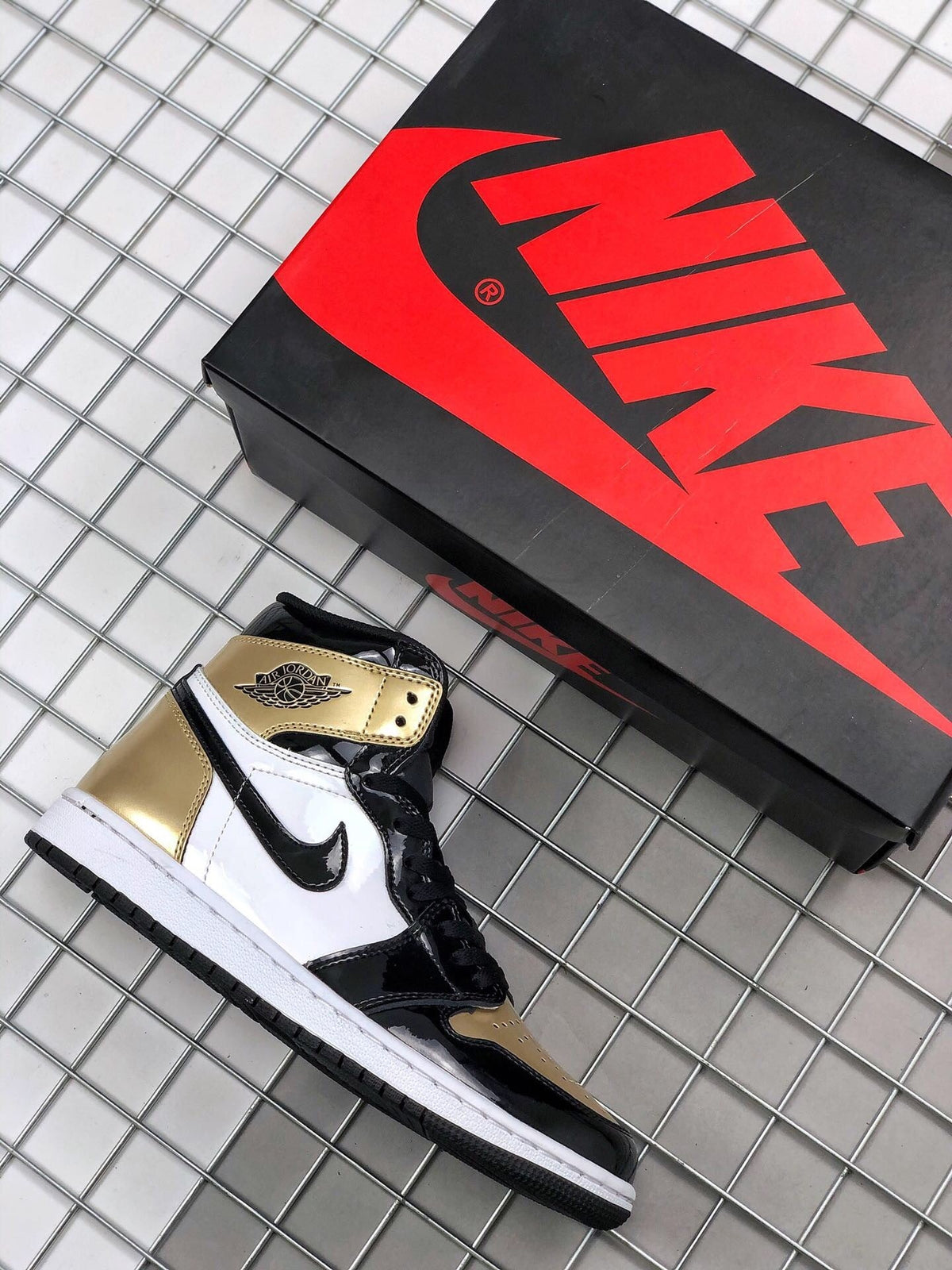 Air Jordan 1 High Gold Toe Sneakers in Black and Gold - product image from the listing.