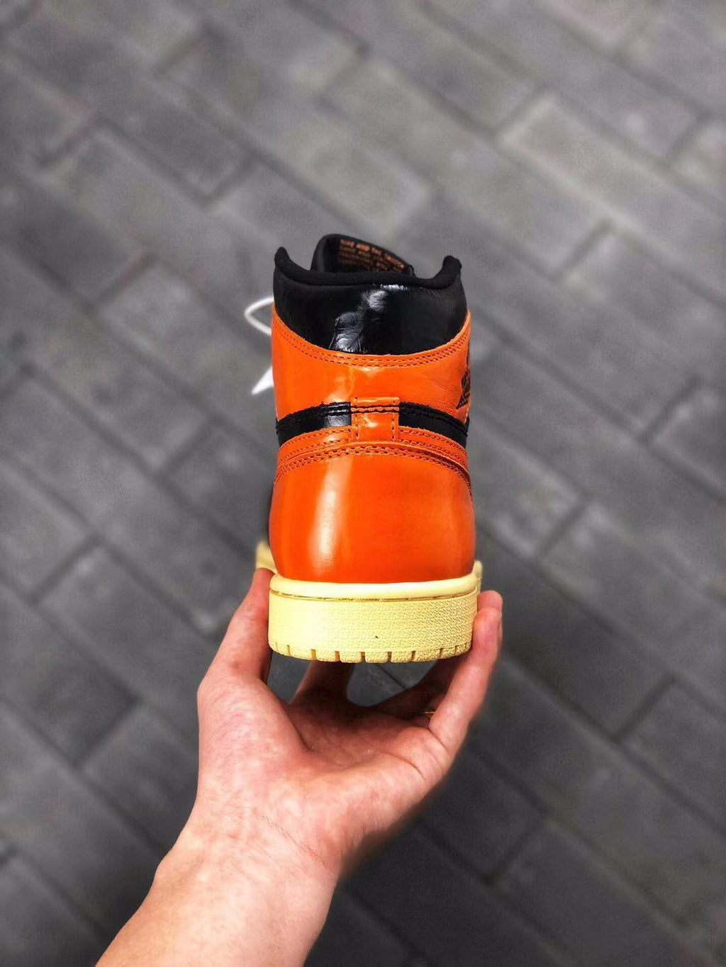 Air Jordan 1 Retro High OG Sneakers in Black and Orange - product image from the listing.