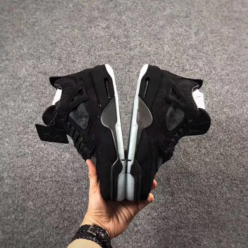 Jordan 4 KAWS Graffiti High-Top Sneakers in Black - product image from the listing.