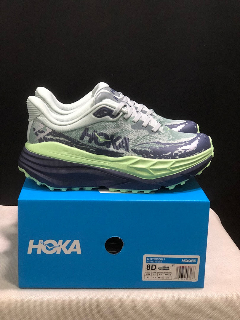 HOKA Stinson 7 Trail Running Shoes, in Green and Navy - product image from the listing.