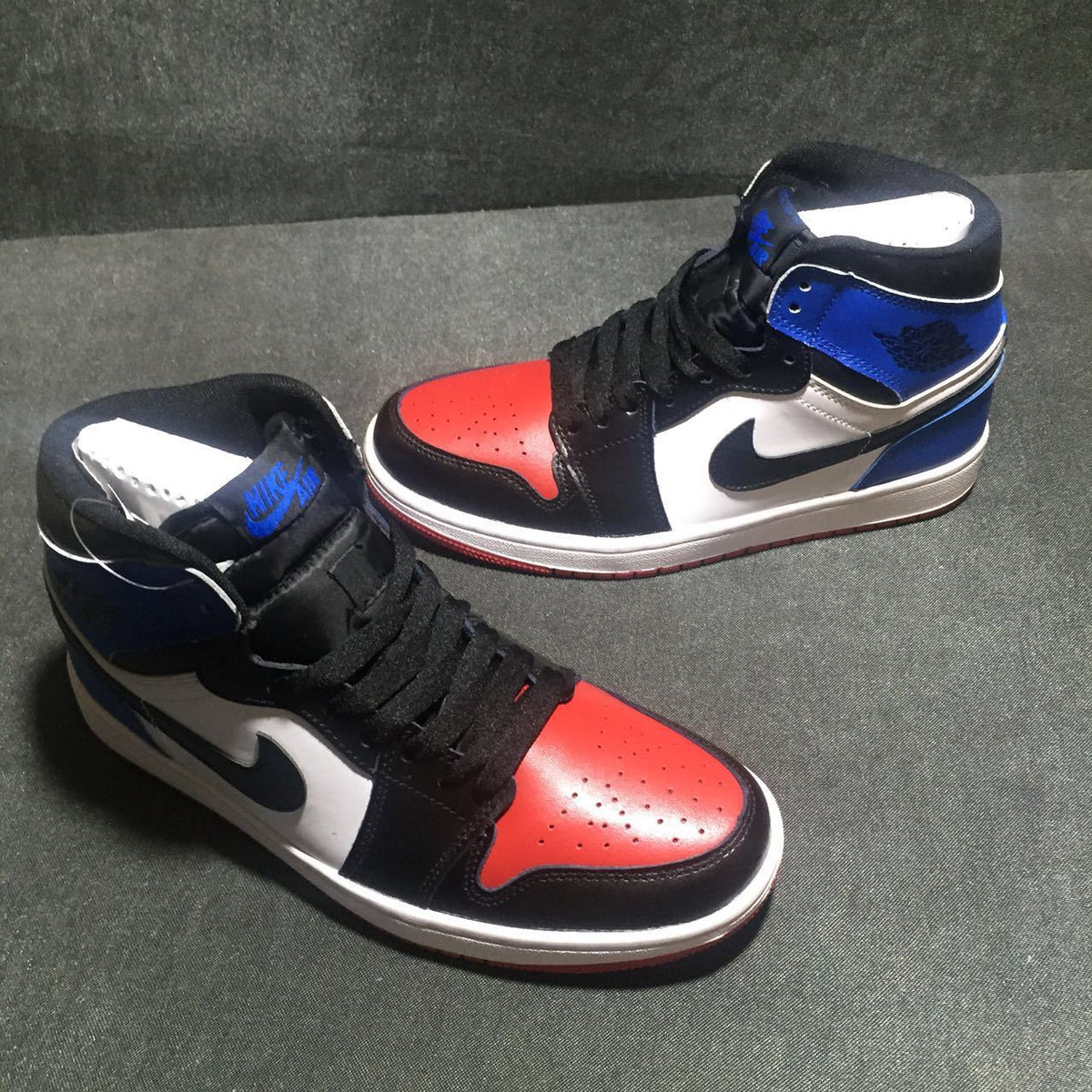 Jordan 1 High Three-Color Sneaker in Black, in Blue and Red - product image from the listing.