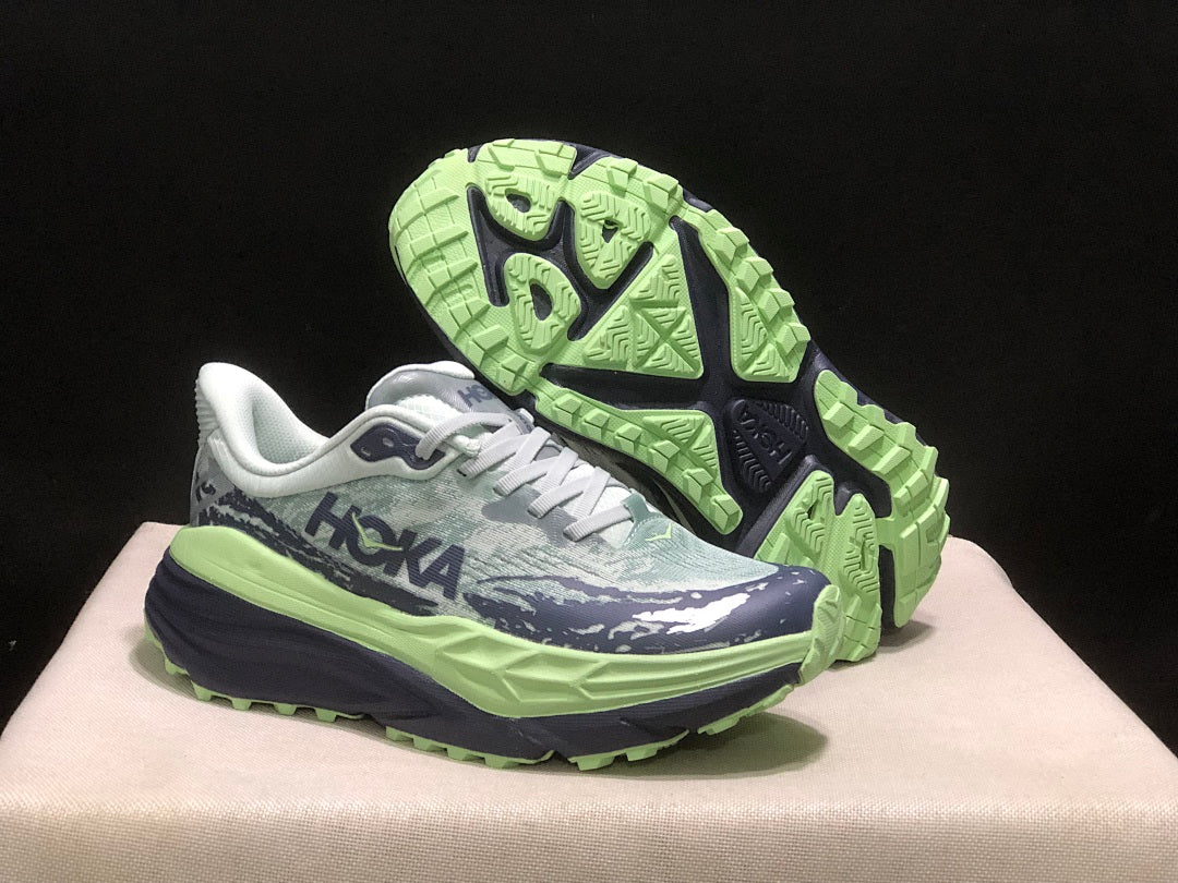 HOKA Stinson 7 Trail Running Shoes, in Green and Navy - product image from the listing.