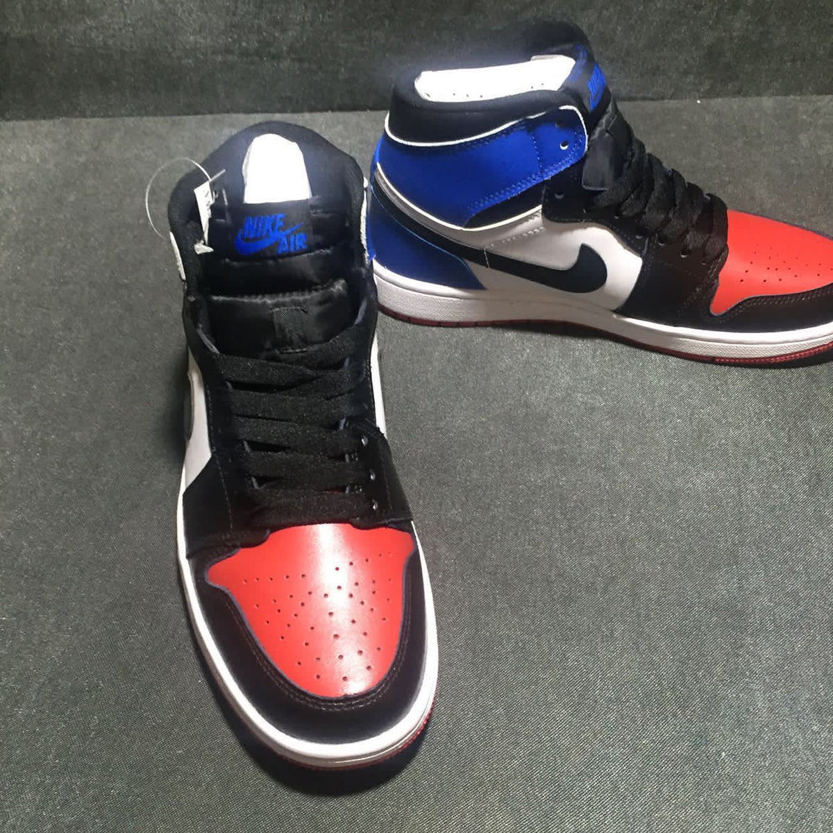 Jordan 1 High Three-Color Sneaker in Black, in Blue and Red - product image from the listing.