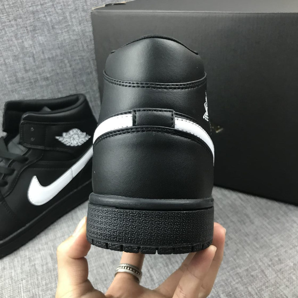Air Jordan 1 Mid Sneakers in Black White 554724-049 - product image from the listing.
