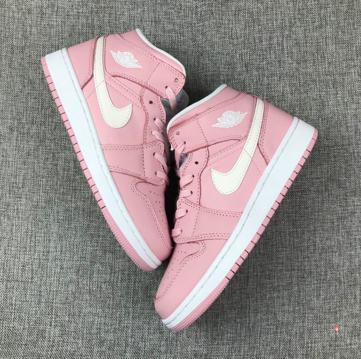 Women's Jordan 1 Mid Pink Sneakers 555112-100 - product image from the listing.