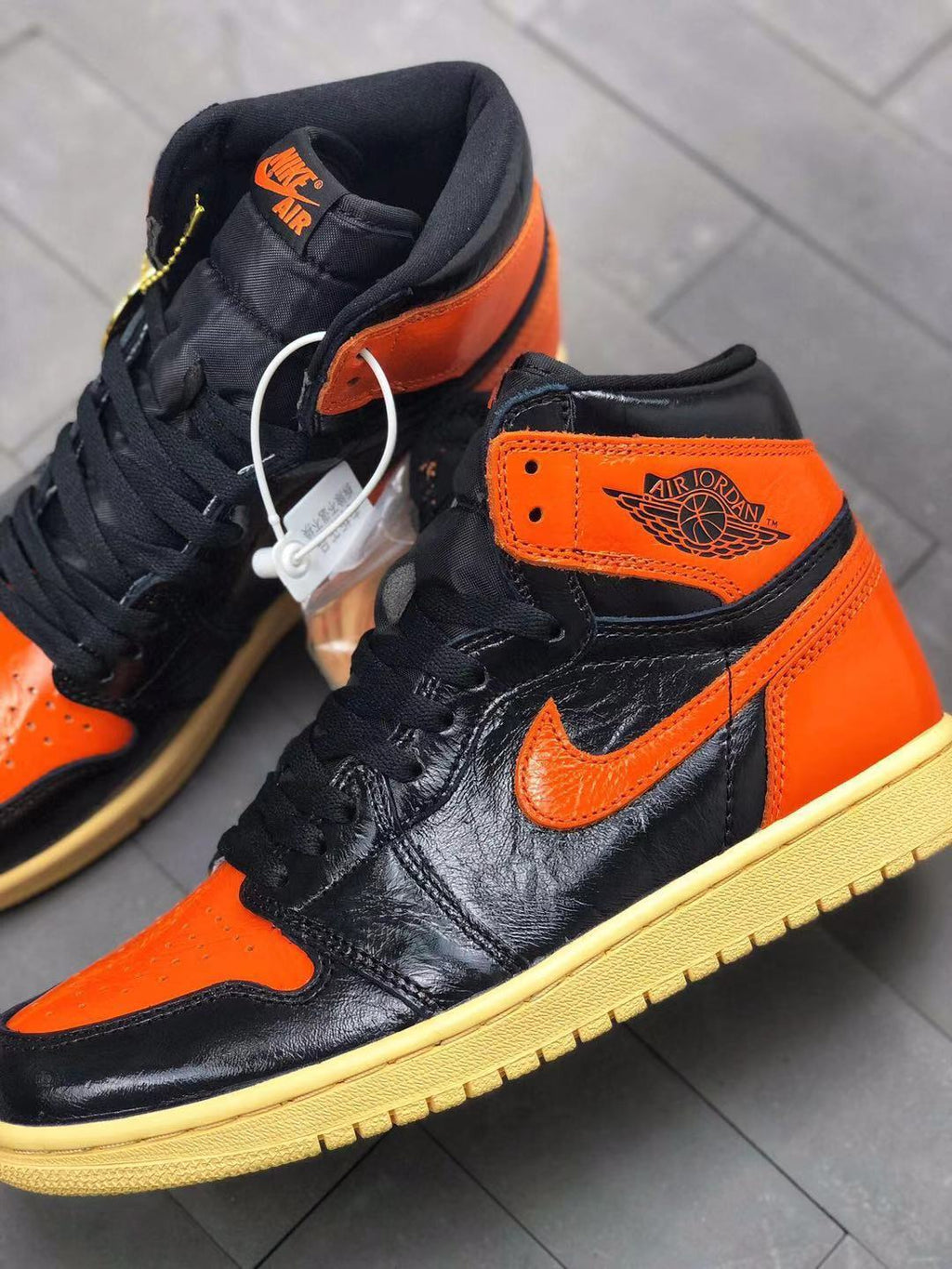 Air Jordan 1 Retro High OG Sneakers in Black and Orange - product image from the listing.
