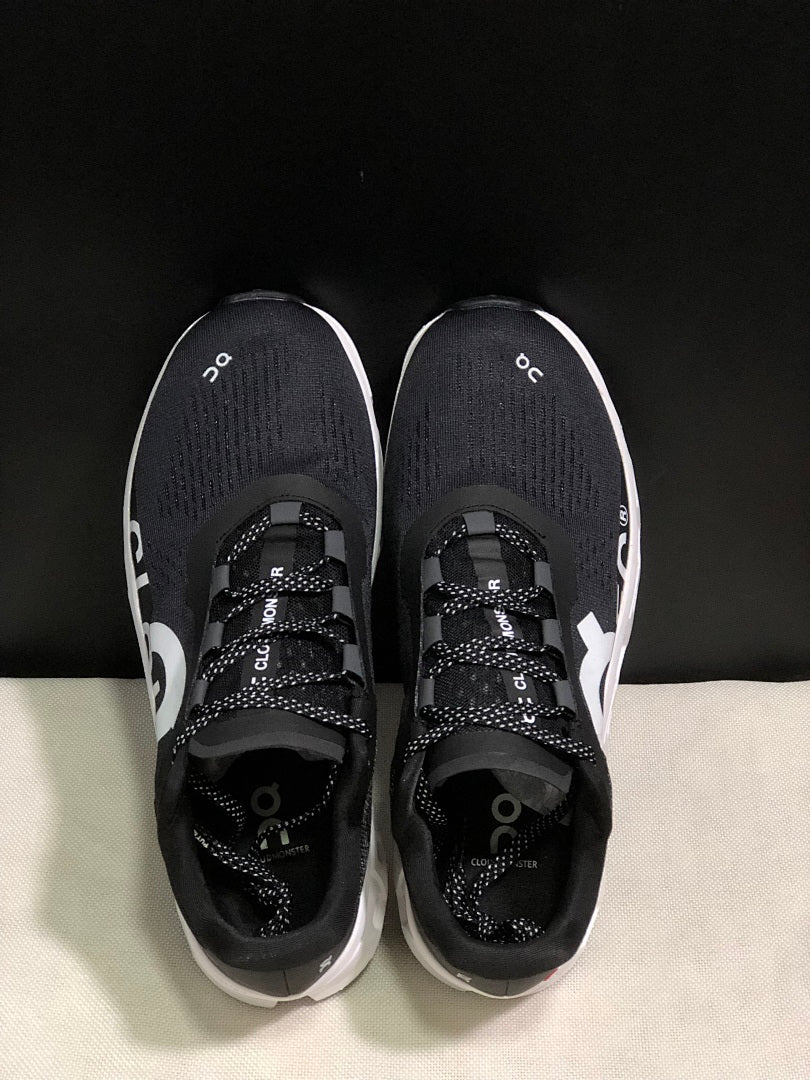 On Cloudmonster Running Sneakers in Black and White - product image from the listing.