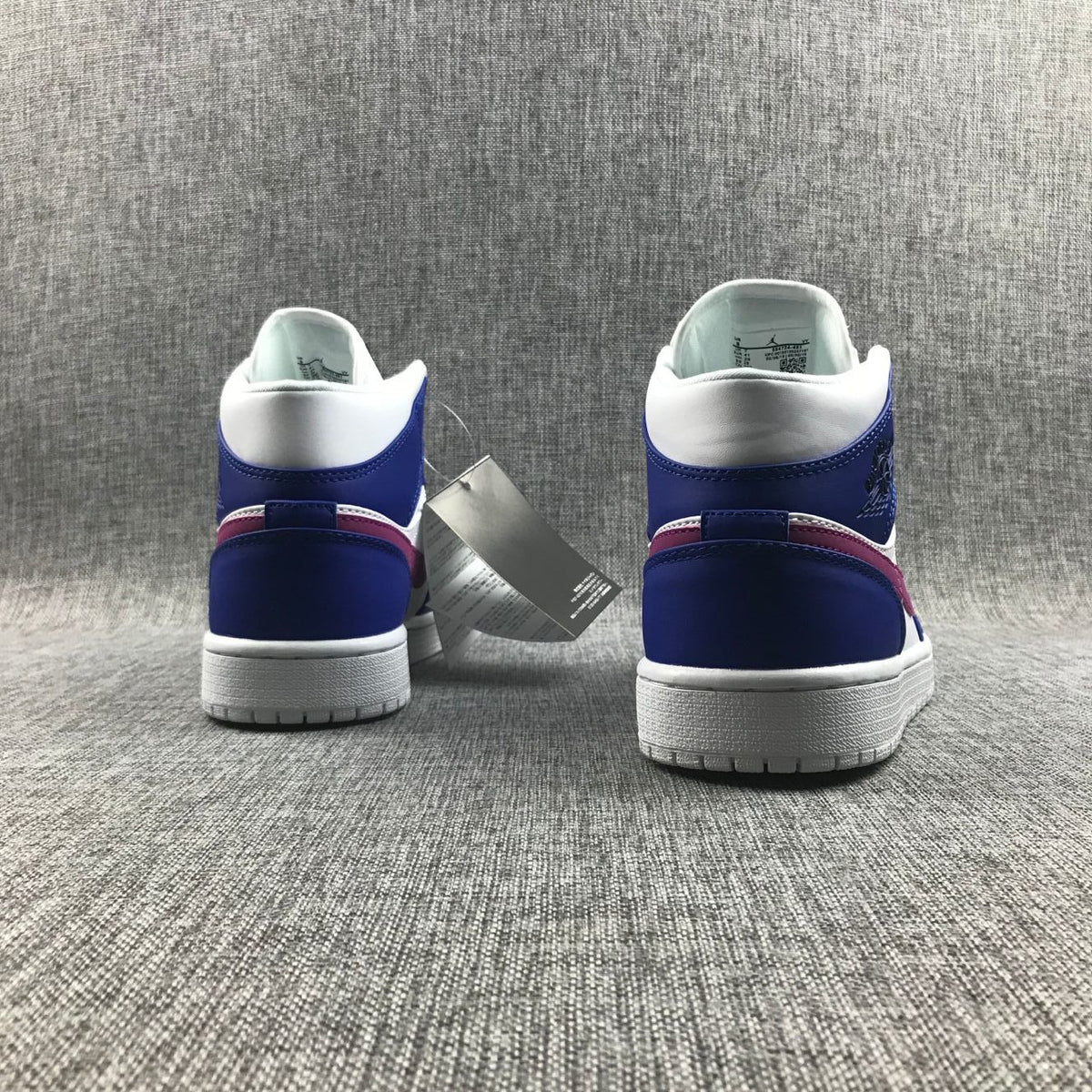 Air Jordan 1 Mid Sneakers in Blue Pink 554724-451 - product image from the listing.