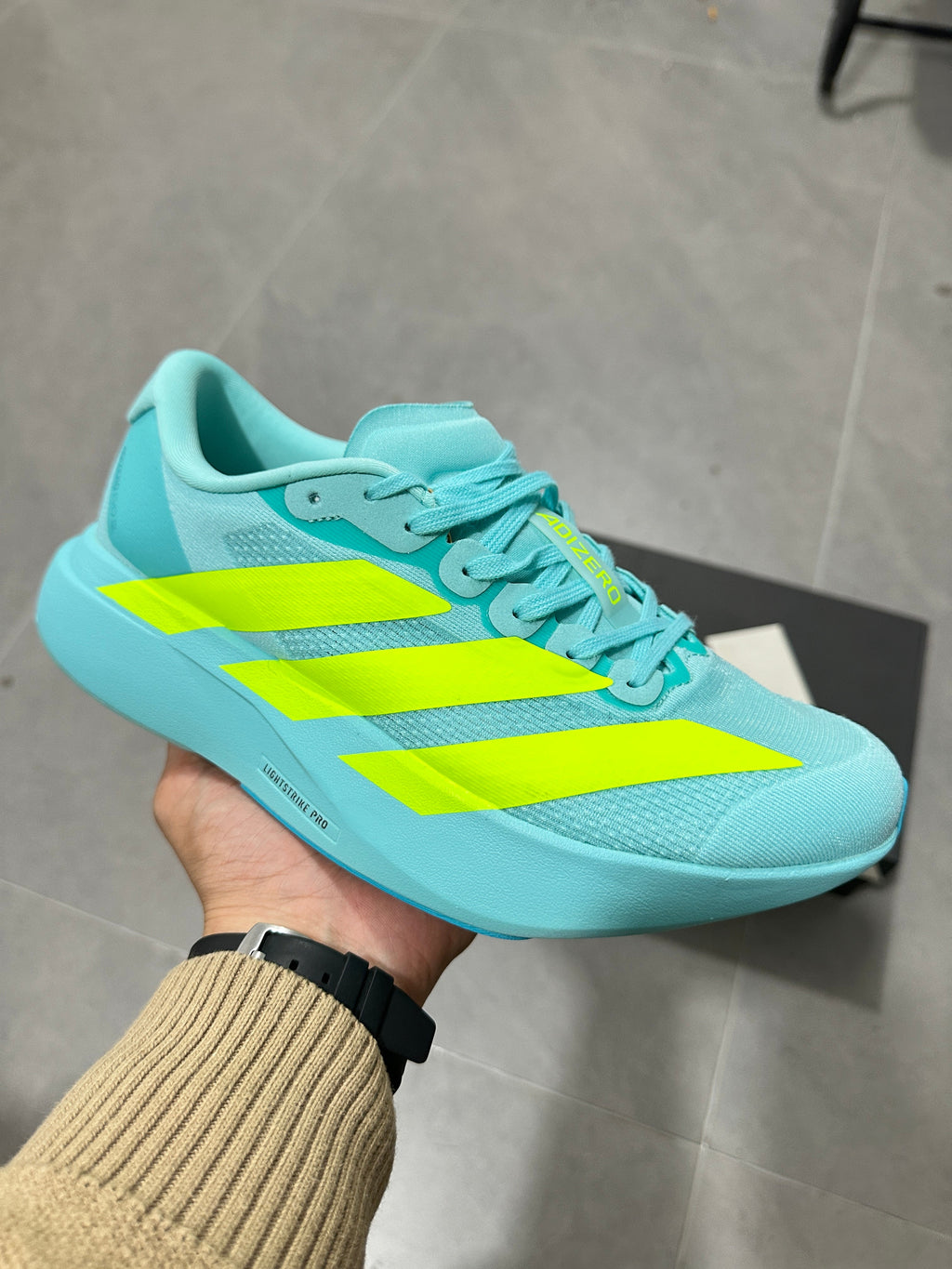 Adidas Lightstrike Pro Running Shoes, in Turquoise and Volt - product image from the listing.