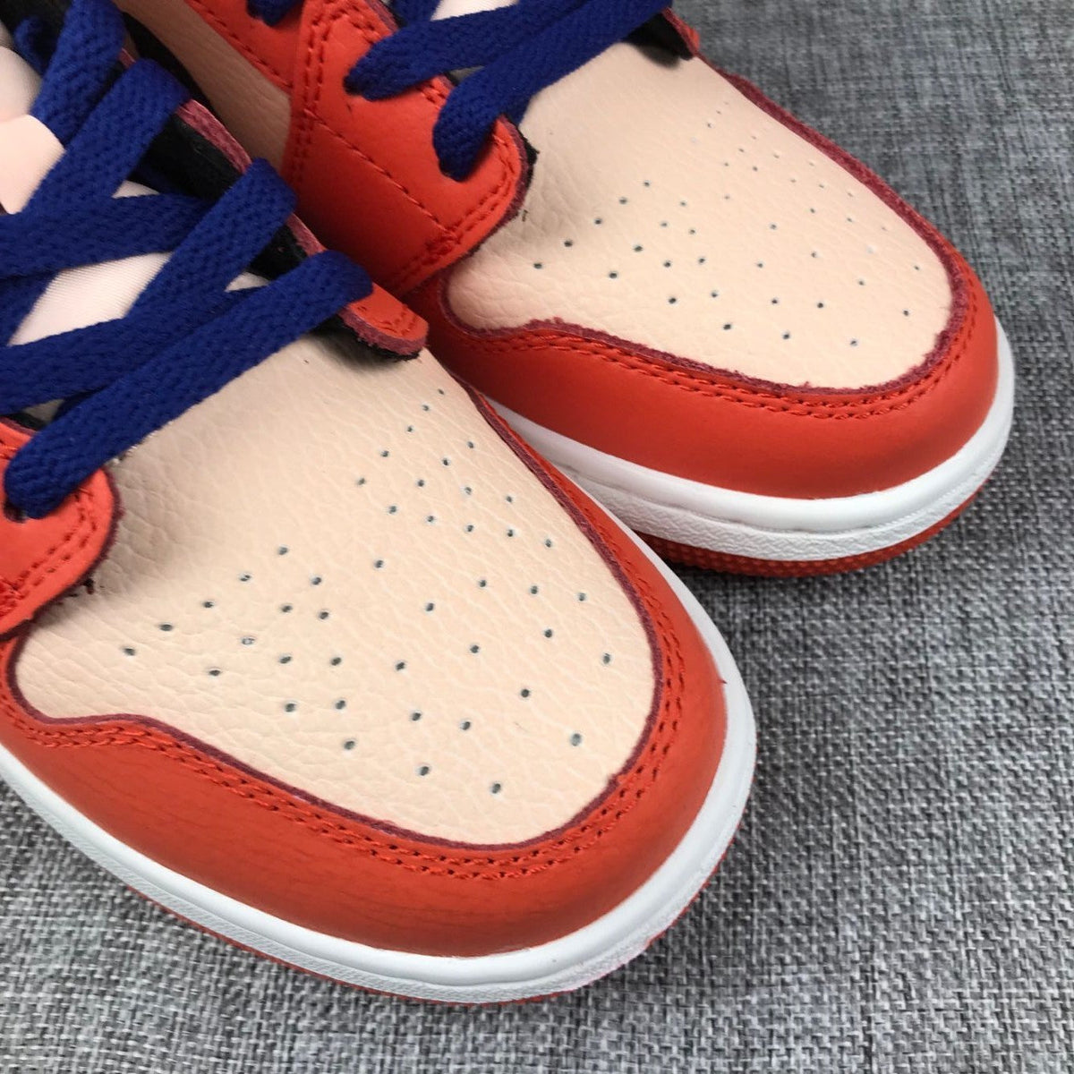 Air Jordan 1 Mid GS Sneakers in Pink and Orange - product image from the listing.