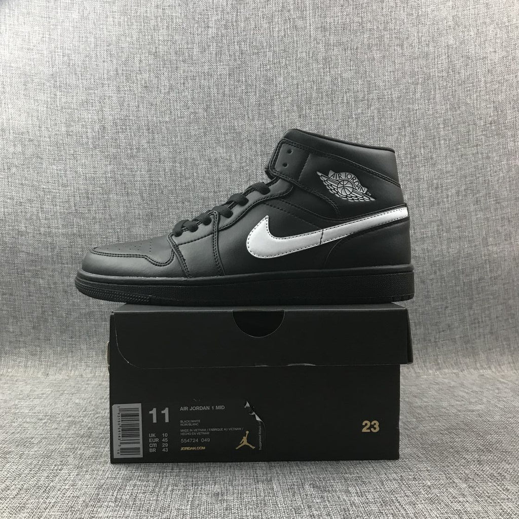 Air Jordan 1 Mid Sneakers in Black White 554724-049 - product image from the listing.