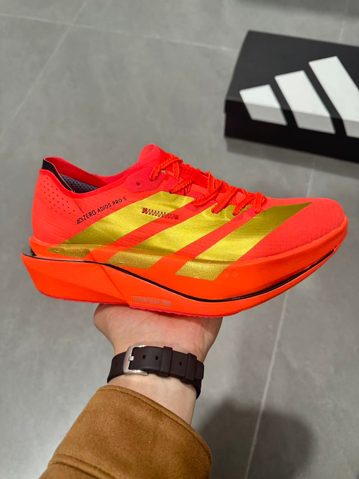 Adidas Adizero Adios Pro 5 Running Shoes, in Red and Lime - product image from the listing.