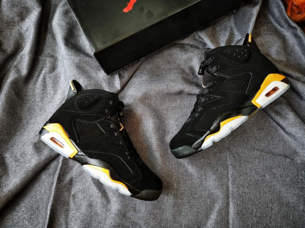 Air Jordan 6 High-Top Sneakers in Black and Gold - product image from the listing.