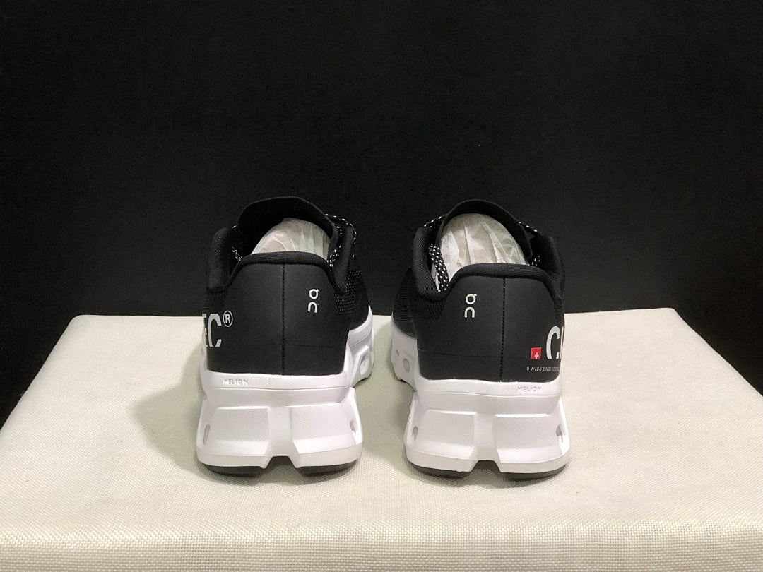 On Cloudmonster Running Sneakers in Black and White - product image from the listing.