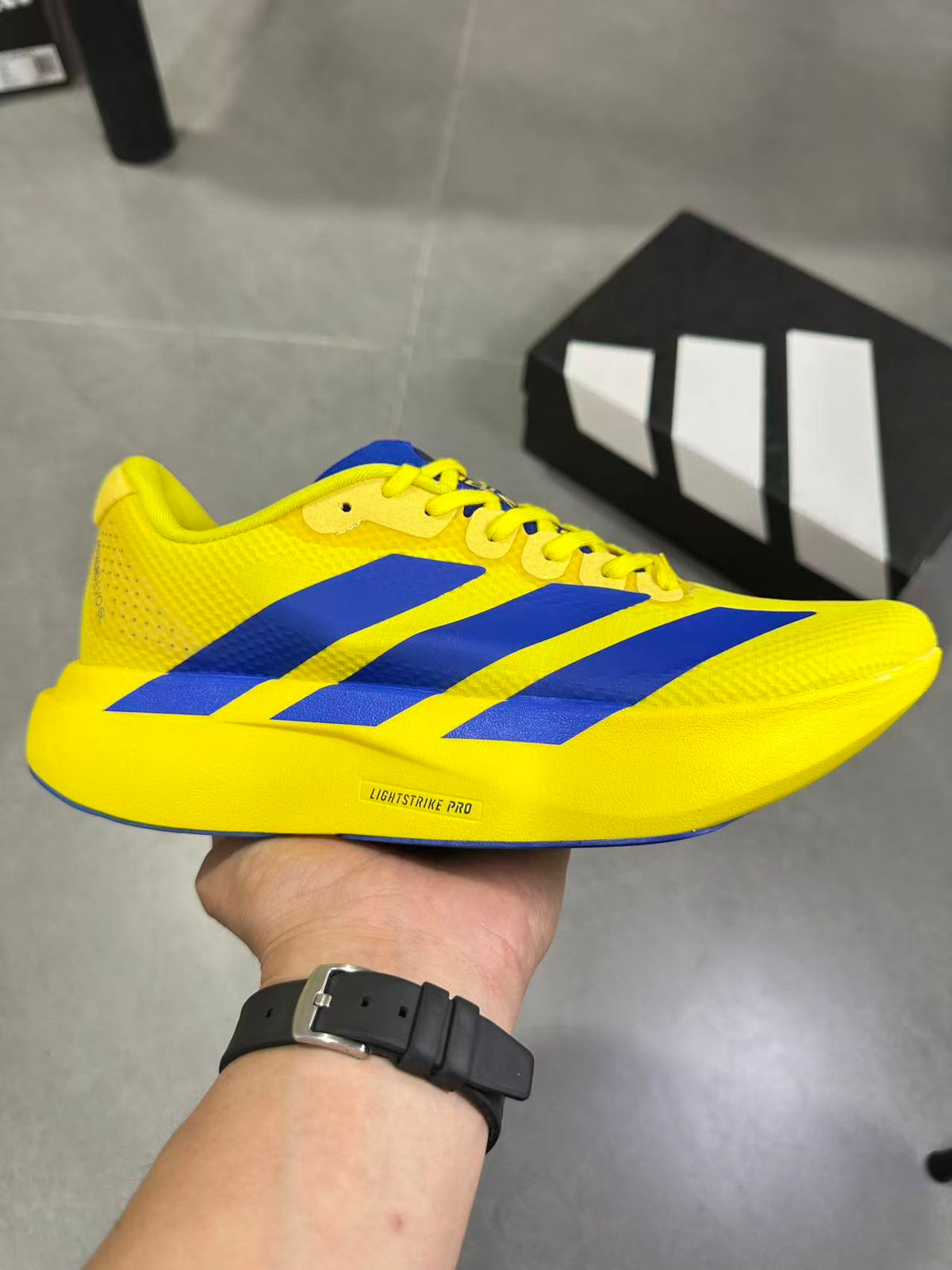 Adidas Lightstrike Pro Running Shoes, in Yellow and Blue - product image from the listing.